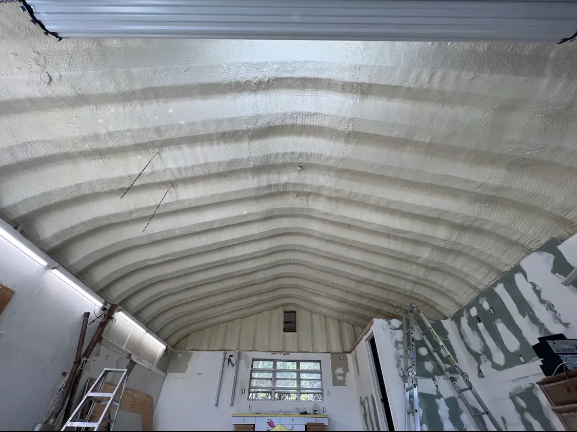 Spray polyurethane foam applied to the underside of a metal roof deck in Madisonville